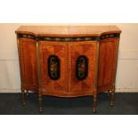 A Sheraton style inlaid painted satinwood side cabinet with floral decoration on ebonised ground,