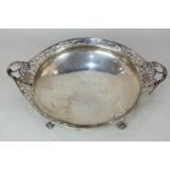 A George V silver bowl with pierced scrolling border and lion mask handles on four paw feet, maker