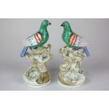 A pair of 19th century Staffordshire pottery green fantail doves, each perched on mossy stump with