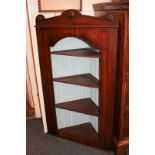 A 19th century mahogany corner wall cupboard with moulded cornice, and glazed panel door enclosing