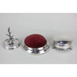 A George V silver dressing table circular box, a silver ring tree and a large silver pin cushion (