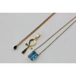 A blue topaz pendant in a 14ct gold mount and hung on an 18ct gold neck chain, an Egyptian gold Ankh