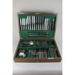 A part canteen of silver plated cutlery, assorted dinner forks, knives, spoons and servers in walnut