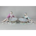 A pair of Meissen porcelain figural dishes of a gallant and lady, both reclining and holding pierced