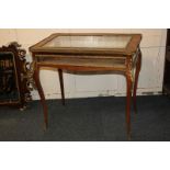 A Louis XV style ormolu mounted kingwood glazed vitrine, lifting top, on slender cabriole legs to