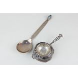 A Scandinavian silver serving spoon with decorative handle and gemstone terminal, and a silver tea