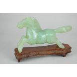 A carved jade figure of a galloping horse, on hardwood stand, 16cm