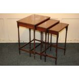 A mahogany nest of three tables with shaped rectangular top, on ring turned supports, 51cm