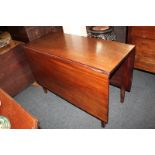 A 19th century mahogany drop-leaf dining table on square tapered legs