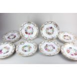 A set of twelve 19th century porcelain dessert plates with hand painted floral design and gilt