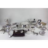 A large collection of silver plated tableware, including a circular entree dish with three