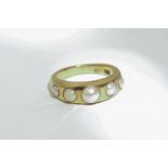 An 18ct gold and pearl ring set with graduated beads, 8.7g gross