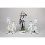 A Naples porcelain figure of a boy fisherman carrying his catch, 19cm, and a pair of porcelain