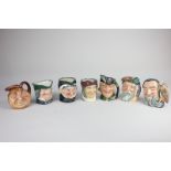 A collection of seven small Royal Doulton character jugs to include Merlin, Robinson Crusoe, and