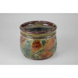 A Royal Doulton natural foliage tobacco jar and cover designed by Christine Abbot, decorated with