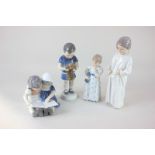 Four Royal Copenhagen porcelain figures of children, including a child holding a puppy, 17cm, and