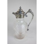 A 19th century silver plate mounted cut glass wine carafe, the handle with embossed mask and