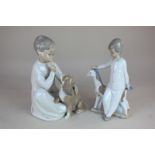 A Lladro porcelain figure of a child, seated with a spaniel, 20cm high and a Nao figure of a child