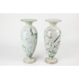 A pair of Victorian green opaque glass vases, baluster shape, decorated with butterflies amongst