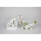 A Continental porcelain dish of boat form, mounted with two cherubs and bocage floral decoration,