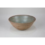 A Bernard Leach studio pottery bowl with green glazed interior, circular impressed seal mark to