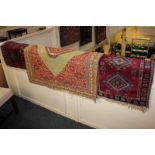 A Persian prayer rug with stepped green central motif on red floral ground, 98cm by 98cm, and a pair