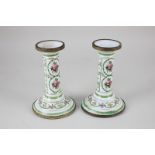 A pair of Continental porcelain candlesticks with gilt metal collars, with floral and gilt