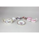 A collection of miniature china tableware including three various cups and saucers, two-handled