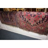 A Persian rug with stepped diamond centre and boteh design on dark blue ground, 131cm by 80cm, and