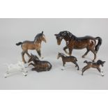 Six Beswick porcelain models of horses, a stocky jogging mare (H855), a Shire foal (No 951), two