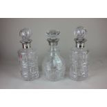 An pair of Elizabeth II silver collared cut glass spirit decanters, makers Roberts & Dove Ltd,