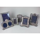 Five silver mounted photograph frames including one with double oval apertures, largest 21cm, and