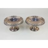 A pair of George V silver circular pedestal dishes, with pierced floral border, maker Blackmere &