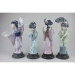 A set of four Lladro porcelain figures of geishas, one with a parasol and a fan, two with fans,