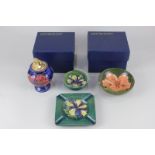 Four pieces of Moorcroft pottery to include an ashtray, a bowl (a/f), a table lighter (a/f), and a