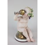 A Giuseppe Cappe porcelain figure of a Bacchanalian cherub drinking from a goblet, with gilt and