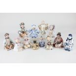 A collection of porcelain nodding head figures of various seated Chinese figures including one