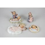 A collection of four Goebel and Hummel figures and plaques including a mother and child, a cherub