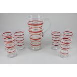 A mid 20th century clear glass lemonade set with red, white and gold stripes