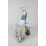 A Lladro porcelain figure of a seated milkmaid with cart and two jugs, 34cm high