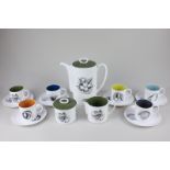 A Susie Cooper porcelain fruit pattern coffee set for six, with harlequin interiors to the cups,