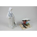 A Goebel Hummel porcelain figure of two children beneath an umbrella, beside a dog, after Norman