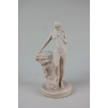 A pottery nude female figure leaning on a rock, 25cm high, the base with incised mark 'Made by W