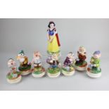 A set of Schmid Snow White and the Seven Dwarfs musical pottery figures marked The Walt Disney