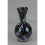 A 20th century black glass vase with millefiori and gilt inclusions, 20cm high