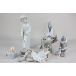 Two Lladro porcelain figures of a child with polar bear and a woman seated on a branch (second)