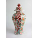 A Chinese porcelain jar and cover of octagonal baluster form, with rust, green and gilt floral