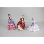 Three Royal Doulton porcelain figures of ladies, Daydreams (HN1731), Top o' the hill (HN1834) and