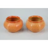 A pair of mid-20th century Chameleon ware pots with speckled orange glaze, 6.5cm high