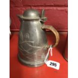 Arts & Crafts: Pewter jug and cover with raffia handle, attributed to Archibald Knox No 0958.